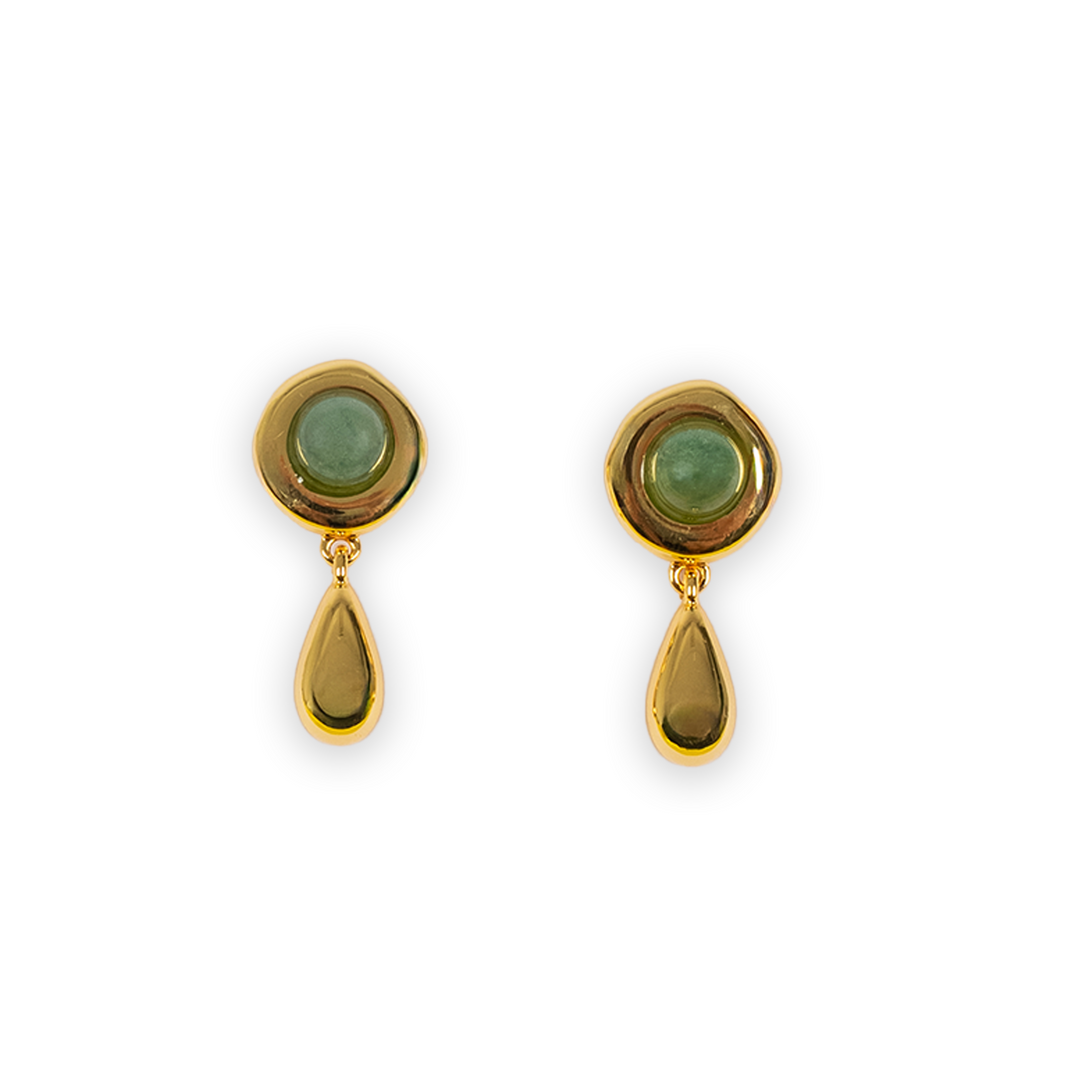 Gold earrings with green gemstones on a white background