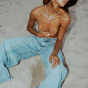 gemstone and pearl jewelry worn by model on the beach